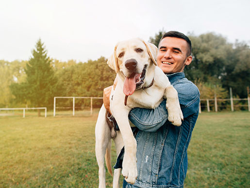 a man and holding his dog