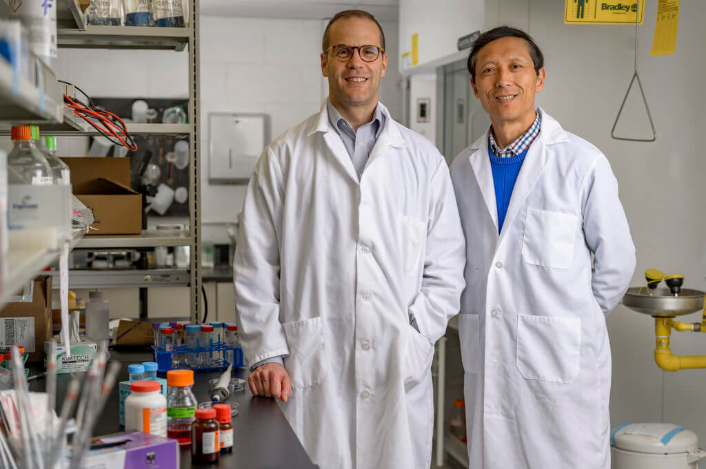 A key factor in the development of Parkinson's disease has been identified by a team of researchers at Purdue University. Jean-Christophe (Chris) Rochet, professor in the Department of Medicinal Chemistry and Molecular Pharmacology in the College of Pharmacy (left) and Dr. Riyi Shi, professor in the Department of Basic Medical Sciences, College of Veterinary Medicine and Weldon School of Biomedical Engineering. The researchers say that the discovery could lead to new therapies, potentially including drugs currently on the market, and it could facilitate earlier diagnosis and prevention of the neurological disorder. (Purdue University photo/Alex Kumar)