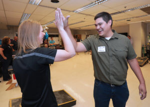 Andrea Brown and Osmar Lopez celebrate cornhole success