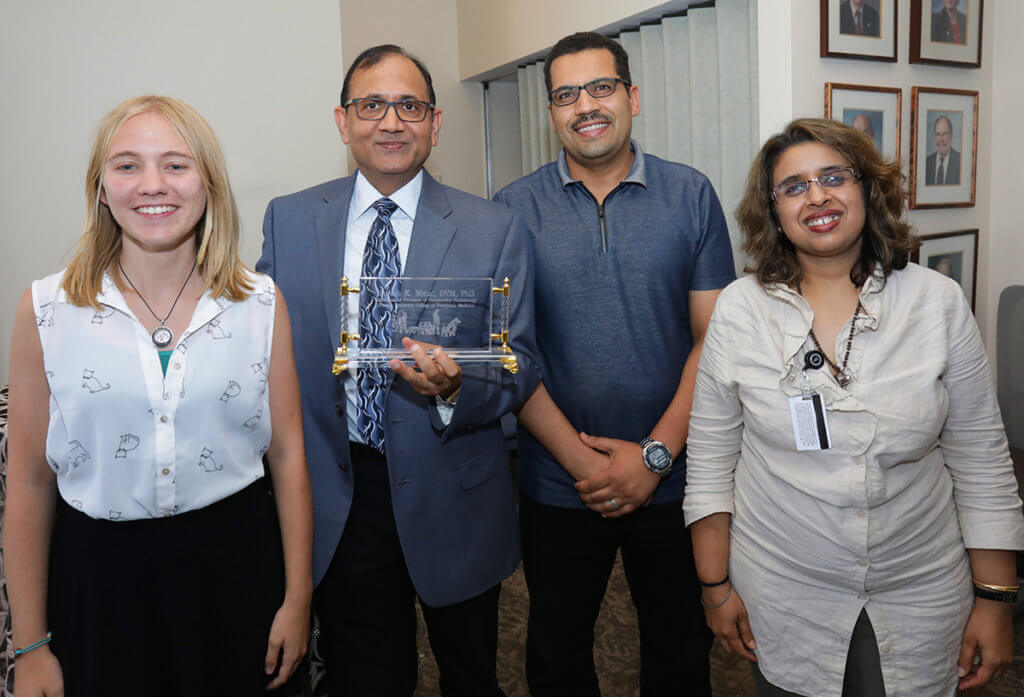 Dr. Suresh Mittal pictured with research team members