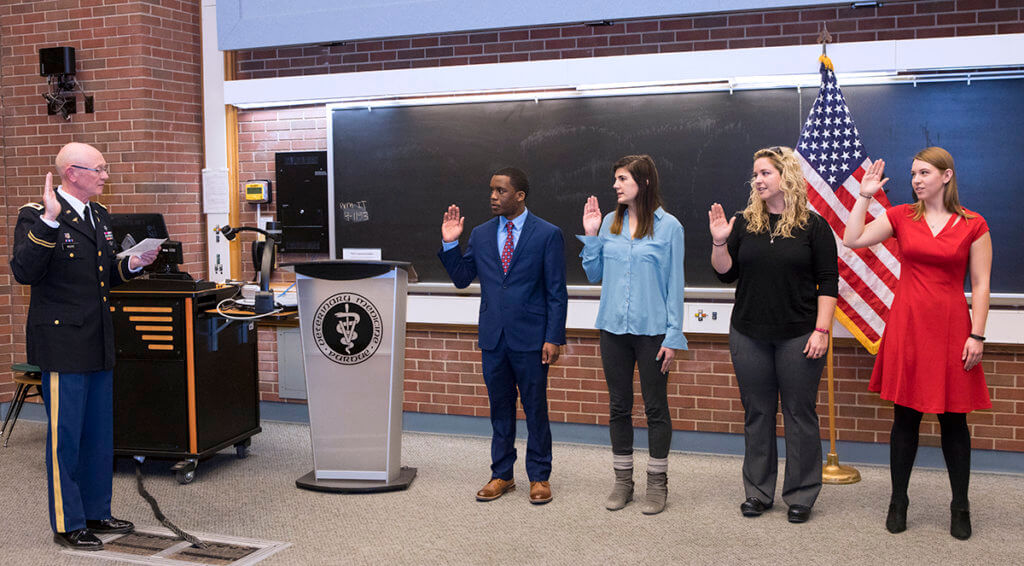 Dr. Moore administers oath of office during commissioning ceremony