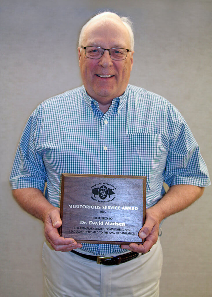 Dr. Madsen pictured with award plaque