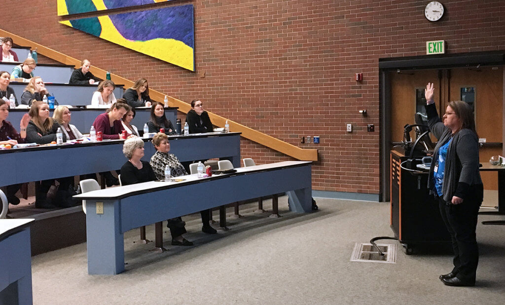 Alicea Howell addresses attendees in a lecture room in Lynn Hall