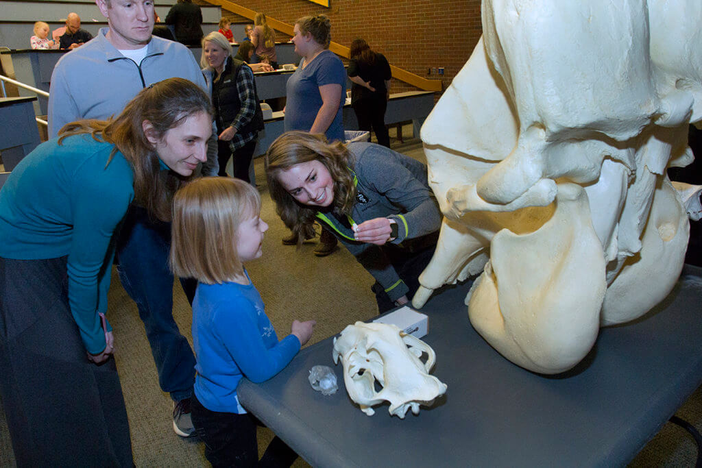 Brittany Rhodes pictured holding a tiny skull for an attendee to see