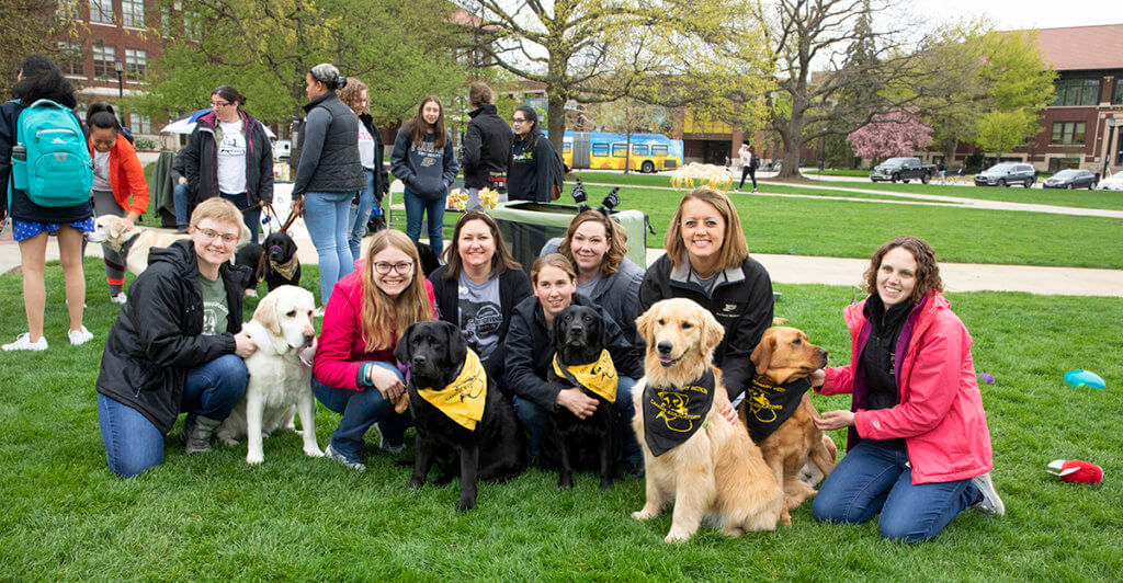 Love a Lab event volunteers and canine educators pause for a photo at Memorial Mall