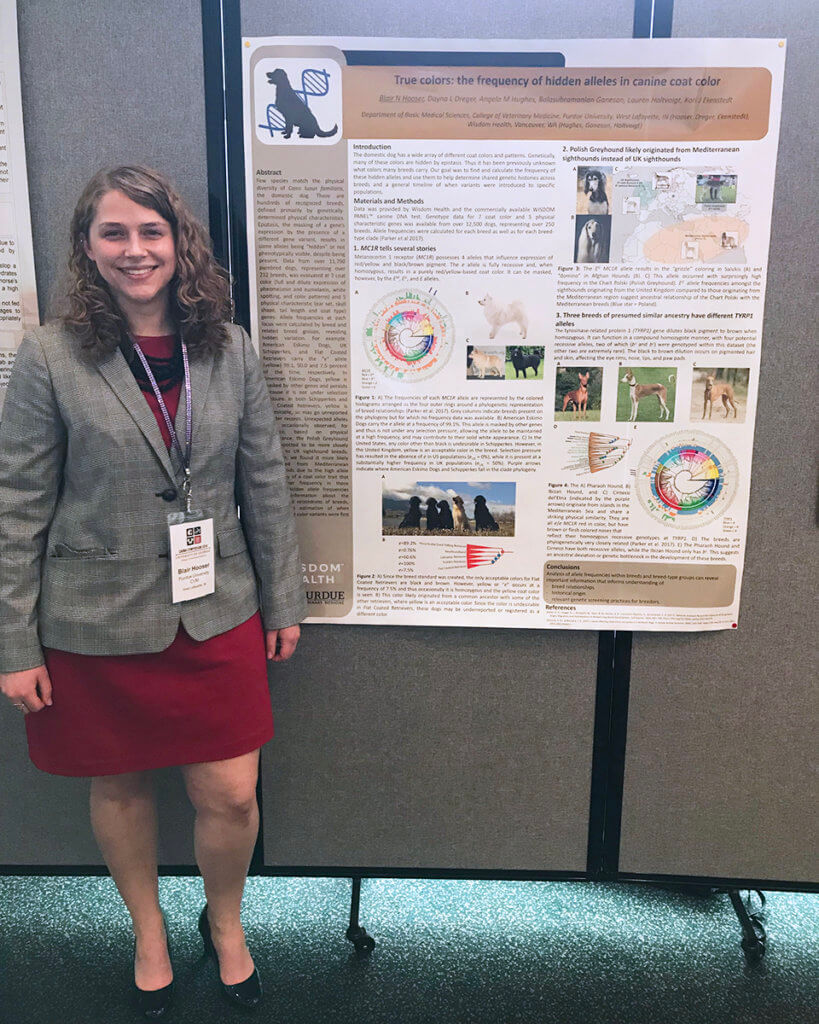 Blair Hooser stands beside her research poster on display