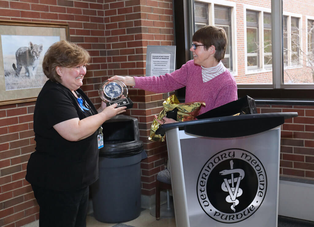 Dr. Knapp hands Chris a commemorative clock