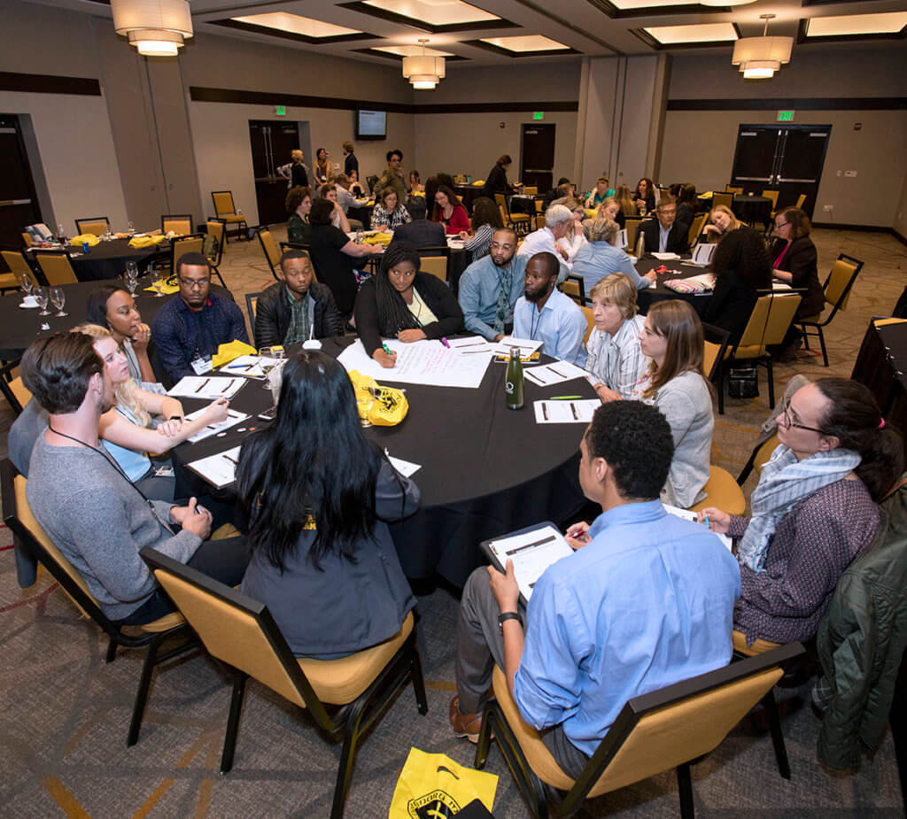 Attendees partipate in group discussions