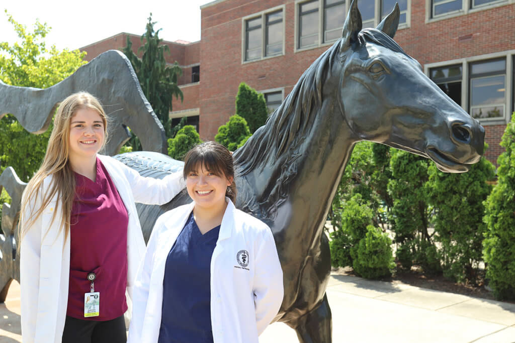 Dr. Mandiola and Dr. Salinas stand together in front of the Continuum sculpture