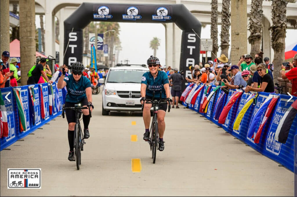 Molly and Sandy ride their bikes along the route just past the start line for Race Across the West