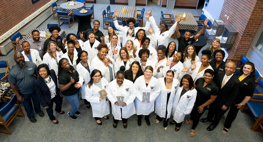 Vet Up! College participants and PVM administrators and teaching assistants gather together in the library for a group photo