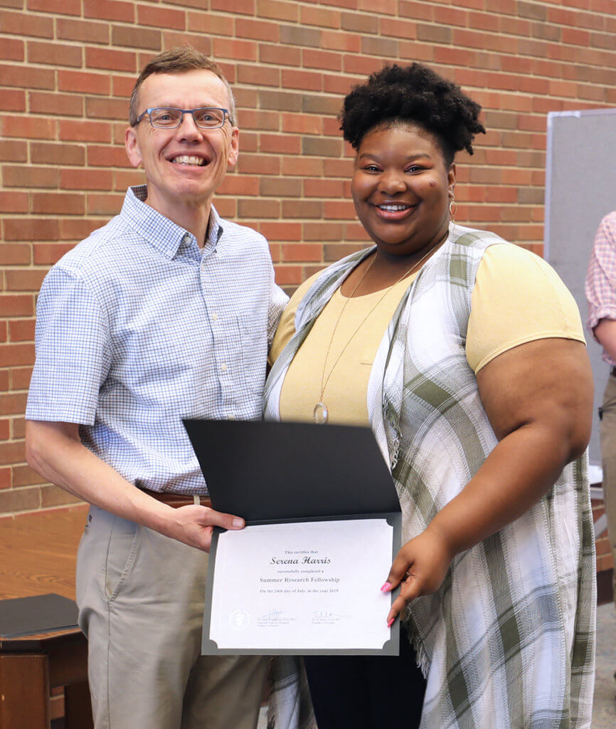 Dr. HogenEsch and Serena hold up her certificate