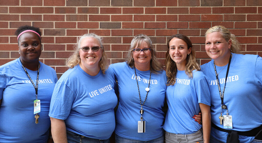 PVM's United Way committee volunteers stand together for a group photo outside Lynn Hall