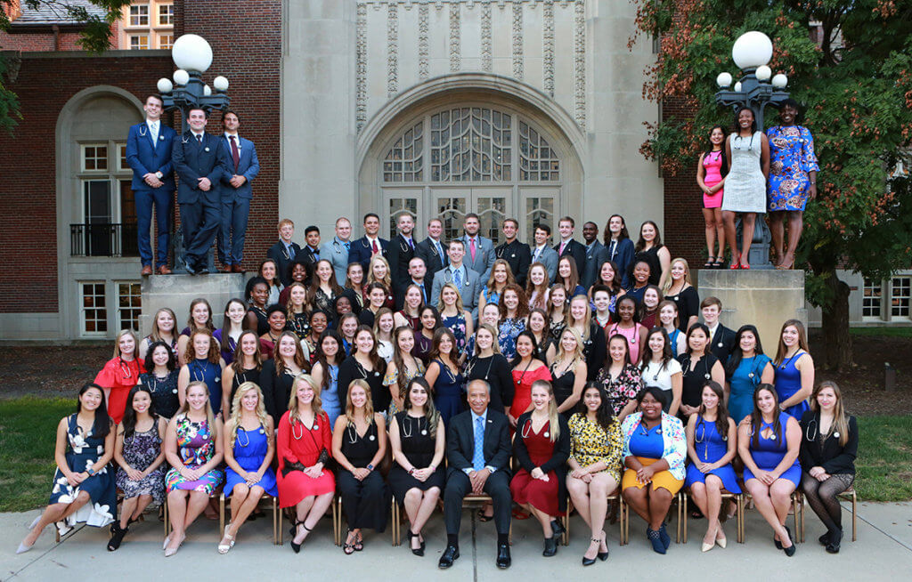 Dean Reed sits in the middle as students surround him outside the entrance to the Purdue Memorial Union