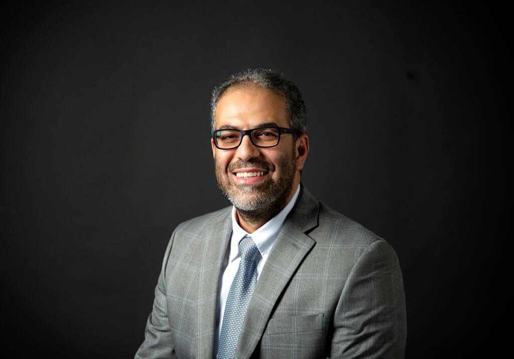 Mohamed Seleem pictured sitting against a dark background