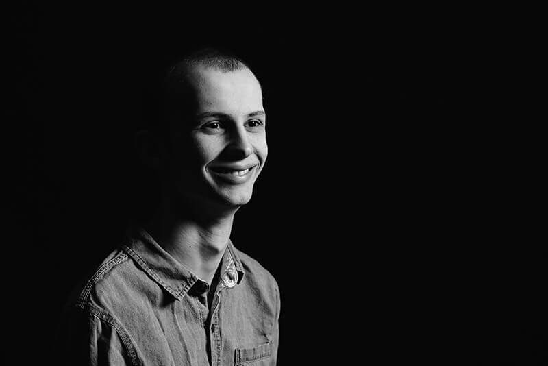 A black and white image of Tyler Trent smiling