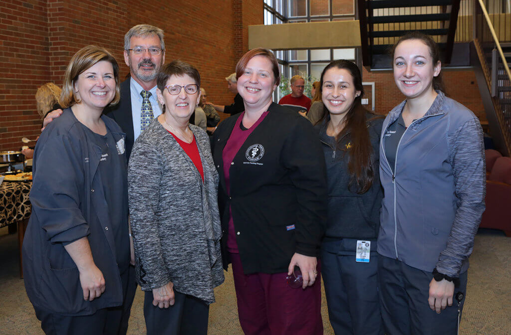 Kris is joined by her colleagues for a group photo in the Veterinary Medical Library following her retirement reception