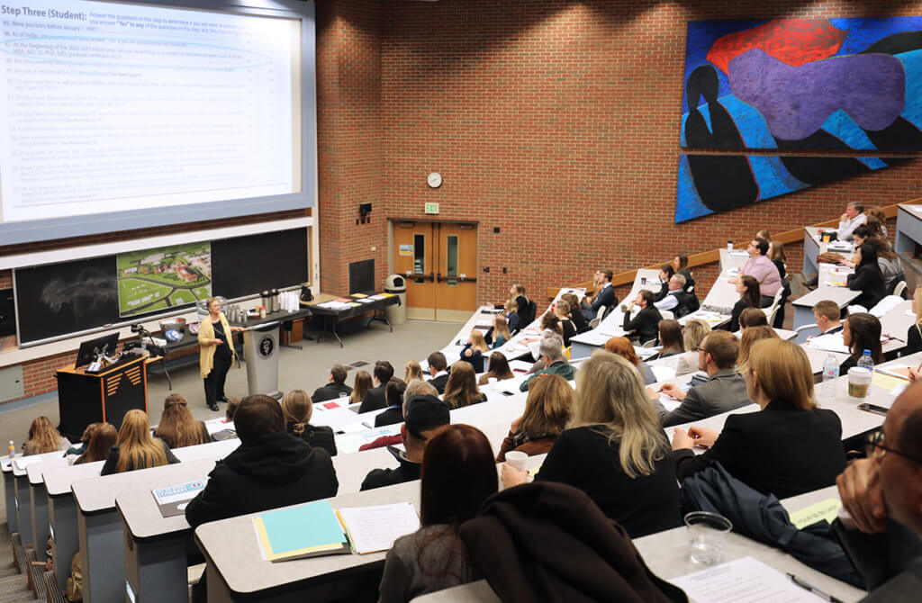 A representative from the Bursar's Office leads a presentation on financial aid to a packed group in Lynn 1136