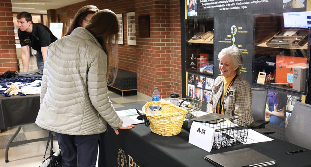 Grace Craig assists interviewees checking in for the DVM interviews