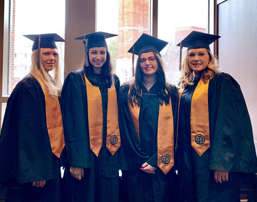 Veterinary nursing students join together for a group photo in their cap and gowns