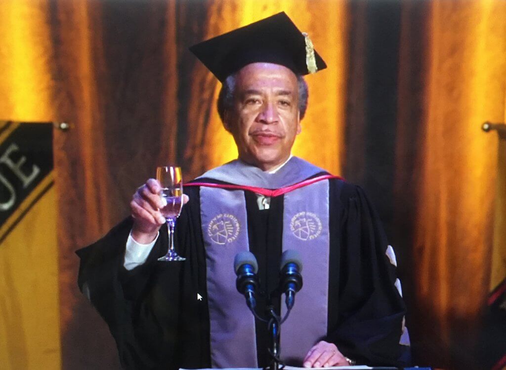 A screenshot of Dean Reed holding up a glass to toast