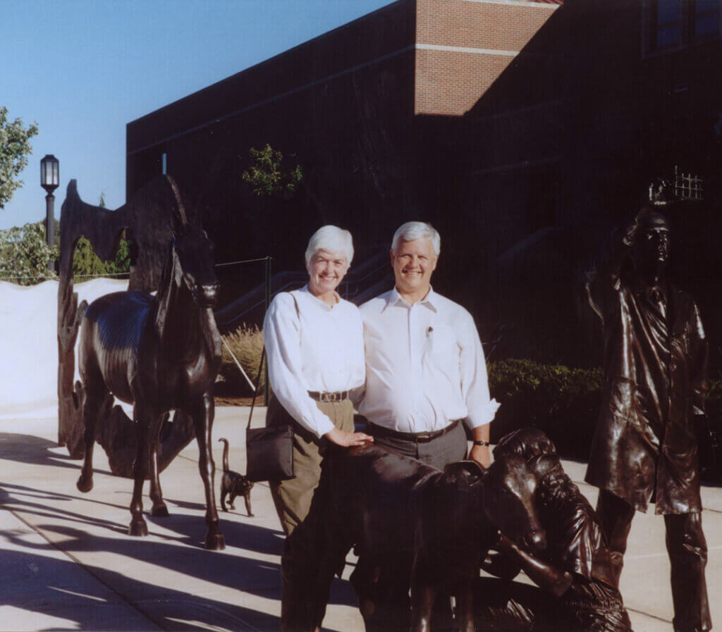 Hugh and Mair stand alongside the sculpture