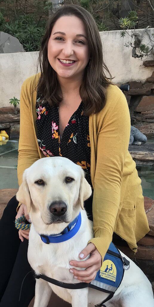 Kerri pictured with a service dog