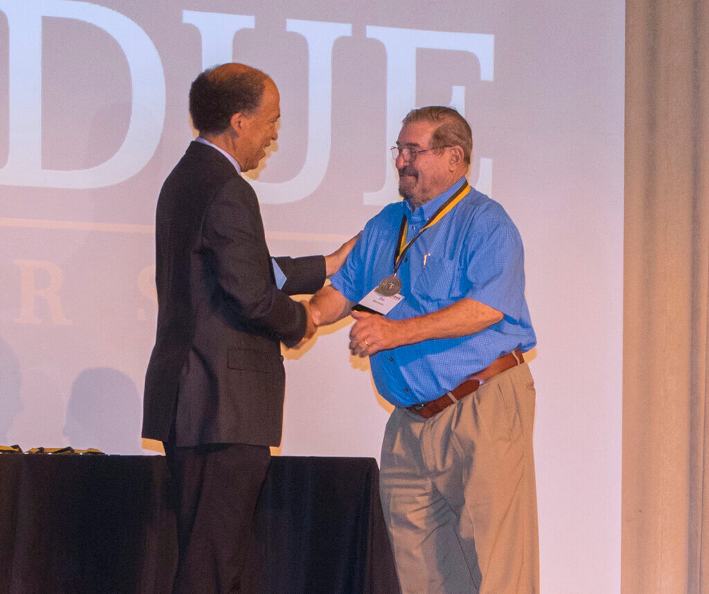 Dean Reed shakes Dr. Matchette's hand in congratulations