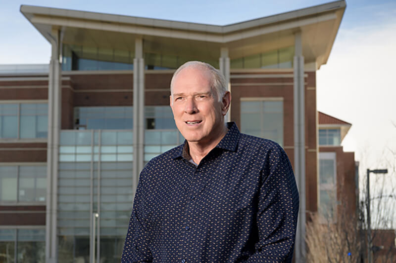 Dr. Low pictured outside in front of a building at Purdue