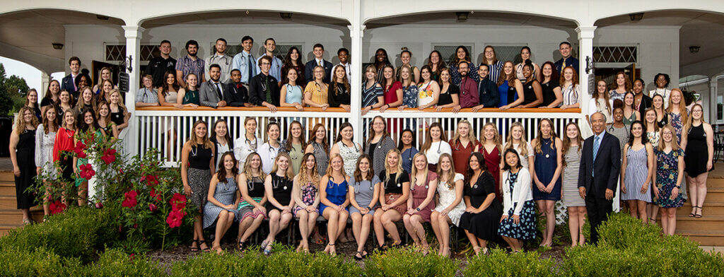 group photo of DVM students and the dean on the steps of the pavilion in Columbian Park