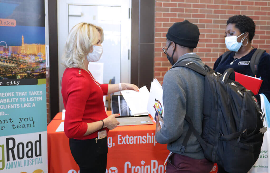 Dr. White shares information with students at her booth