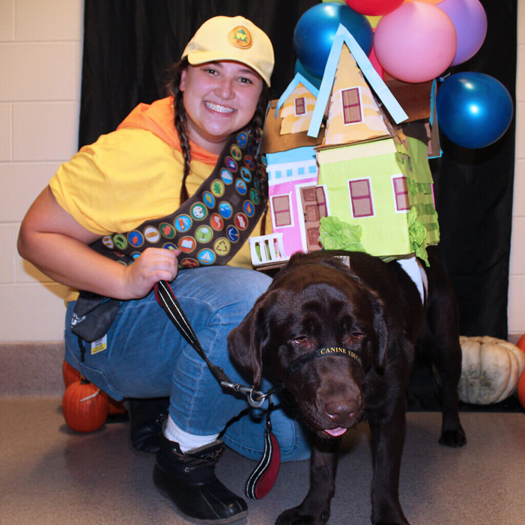 River and his costume partner show off their costumes with River wearing the Up house along with balloons on his back and his care team member dressed as scout, Russell
