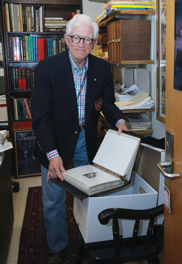 David Williams smiles as he boxes up archival materials in his office