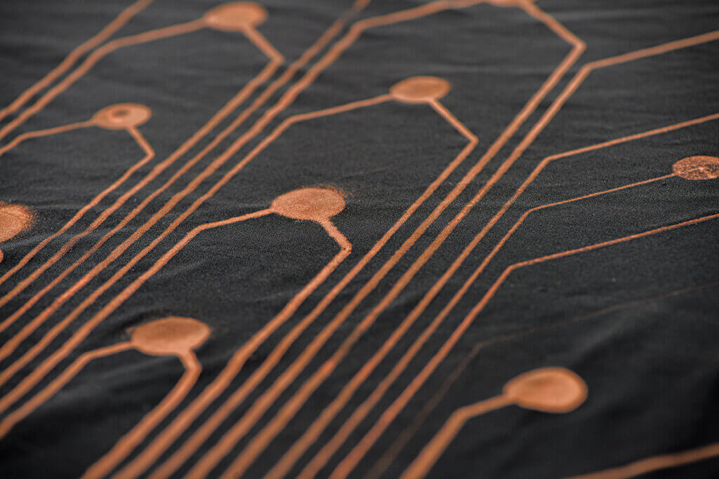 A close up of the orange sensors shown on a black slicker