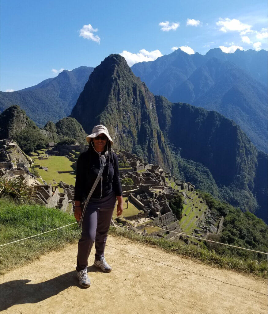 Camille stands in Peru with Machu Pichu in the background