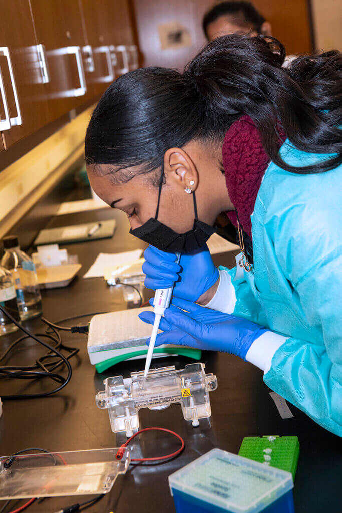 Cynamon works intently at a lab station