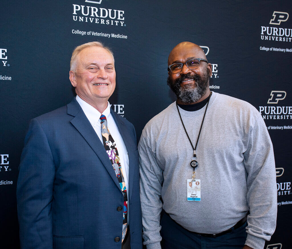 Dr. Baird and Dr. Ragland stand beside each other smiling at the camera