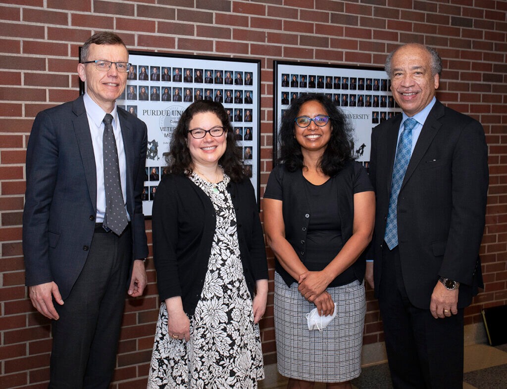 Drs. HogenEsch, Mekaru, Raghavan, and Dean Reed smile into the camera in a hallway of Lynn Hall