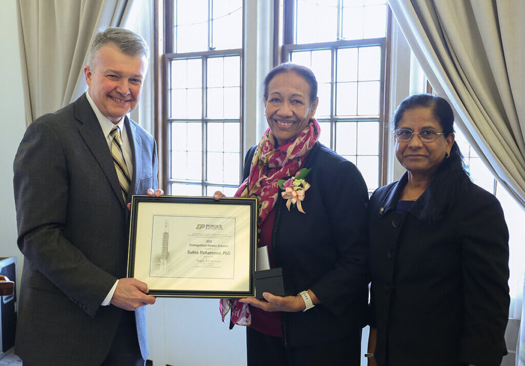 Provost Akridge and Sulma hold up her recognition certificate as their joined by Dr. Subramanian