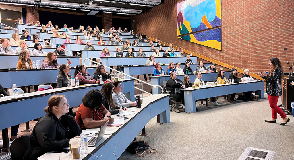 A full classroom of attendees listen to a presenter during the Veterinary Nursing Symposium