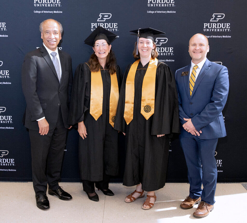 Dean Reed and Chad Brown join Veterinary Nursing Distance Learning graduates Brenda and Jennifer for a group photo. Brenda and Jennifer are wearing their cap and gown.