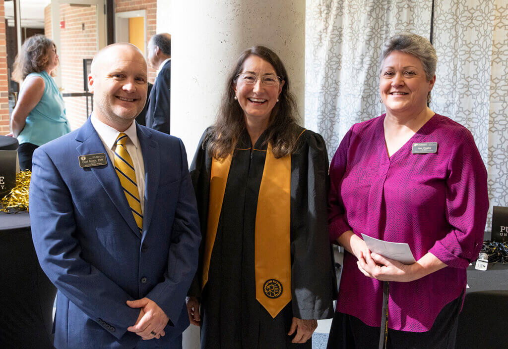 Brenda smiles as she's joined by Dr. Brown and Pam at a reception in the Continuum Café in Lynn Hall