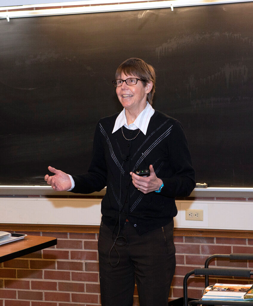 Dr. Knapp speaks to the audience from the front of a lecture room in Lynn Hall