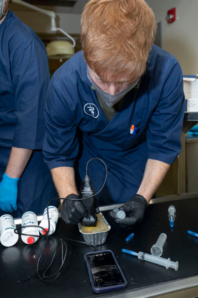 student using the ultrasound device paired with their smartphone