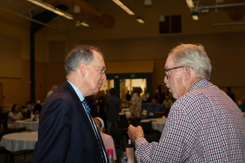 Featured forum speaker Andrew Rowan, PhD, of Animal Well-being International, talks with a Forum participant during a break.