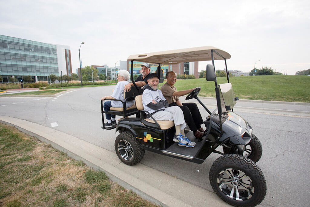 Dean Reed gives some participants a ride in a golf cart