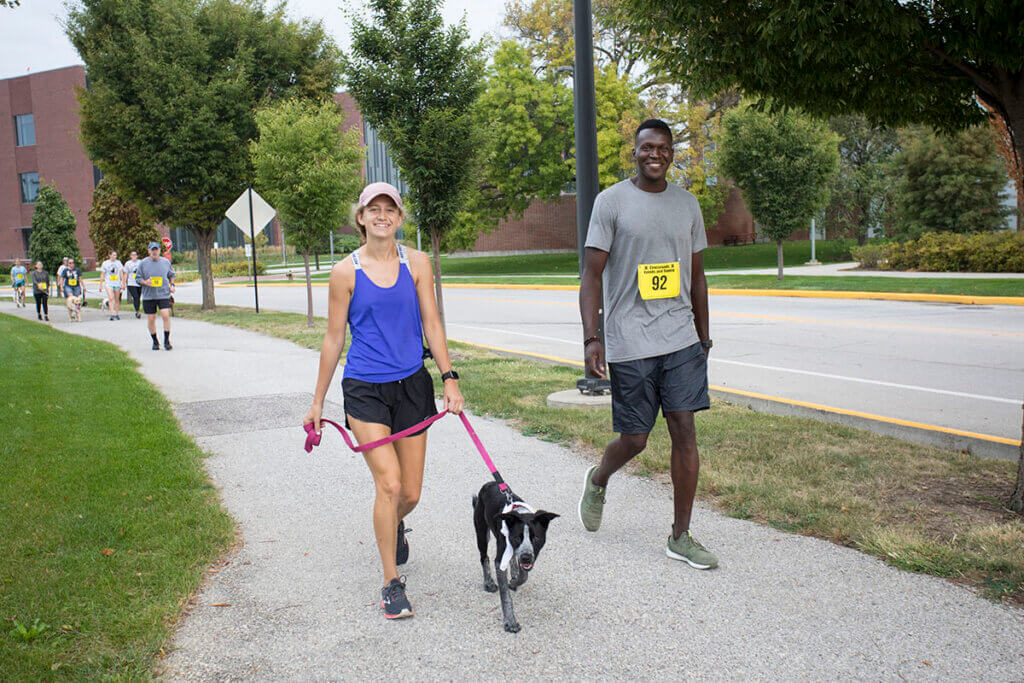 two participants of the dog jog with their dog