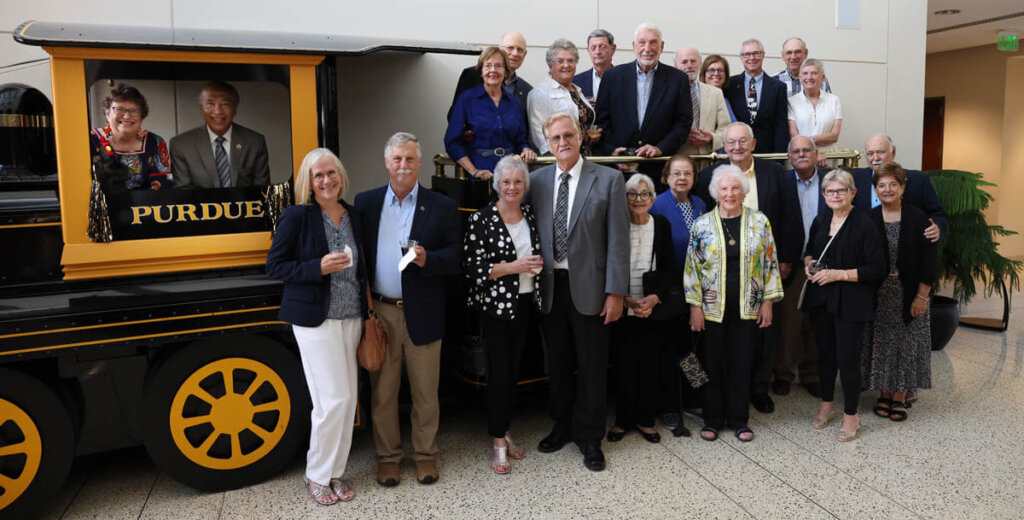 Purdue Veterinary Medicine faculty emeriti and their spouses gather for a group photo with Dean Willie Reed in the atrium of the Dauch Alumni Center before the 2022 Emeritus Faculty Dinner August 23.