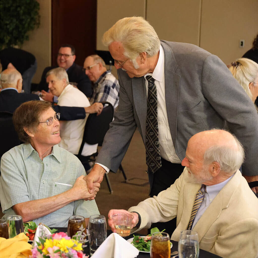 Dr. Steve Adams, professor emeritus of large animal surgery (left) is greeted by Dr. Bill Blevins, along with Dr. Rick Widmer, who both served as professors of diagnostic imaging before retiring.  