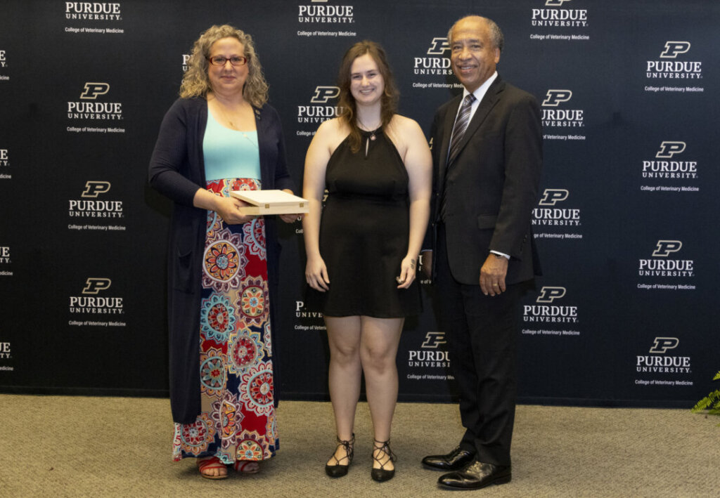 Holly McCalip y Dean Willie Reed con la graduada Justine Henderson, quien recibió el Premio al Mejor Logro Académico.